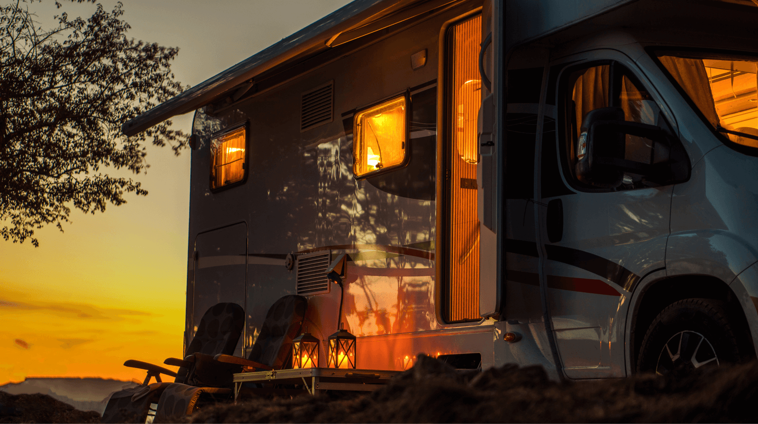 Motorhome with solar, lights on inside setting sun