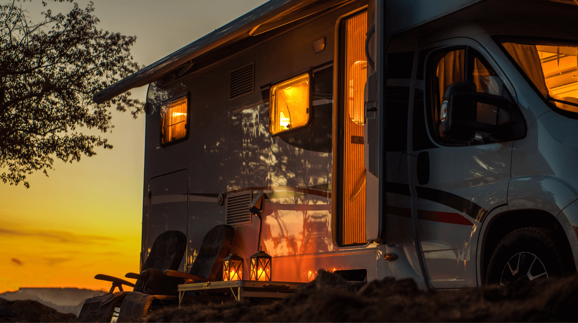 Motorhome with solar, lights on inside setting sun